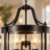 Close-up of the metal arms and glass shade of a lantern pendant