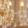 Close-up of copper candle arms and crystal drops