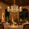 Crystal candle chandelier glowing in a hotel restaurant at night