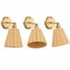 Rattan wall sconce shown at three adjustable angles