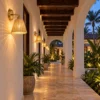 Rattan wall sconces along a villa corridor at dusk