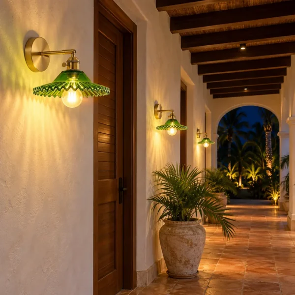 Green glass wall sconces along a villa corridor at night