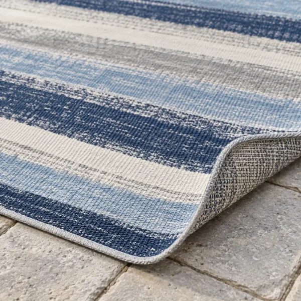 Close-up of thin striped flatweave and rug edge
