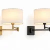 Swing arm wall sconce in brass finish and matte black