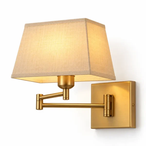 Swing arm bedside wall sconce in brass finish with beige linen shade