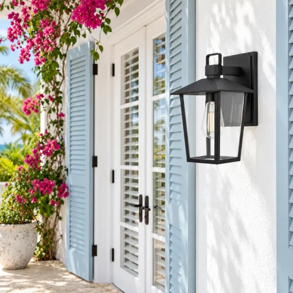 Black outdoor wall lantern beside blue-shuttered French doors on a white facade