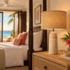 Large travertine table lamp beside a four-poster bed in a Caribbean suite