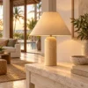 Travertine table lamp with cone shade on a console in a villa living room
