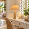 Travertine table lamp with stripe shade on a hotel suite writing desk