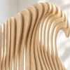 Close-up of curling wave top on plywood slice divider