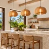 Three wood slat pumpkin pendants over a villa kitchen island
